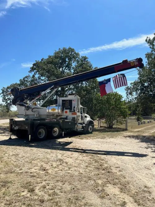 A Truck With Two Flags On The Pulley